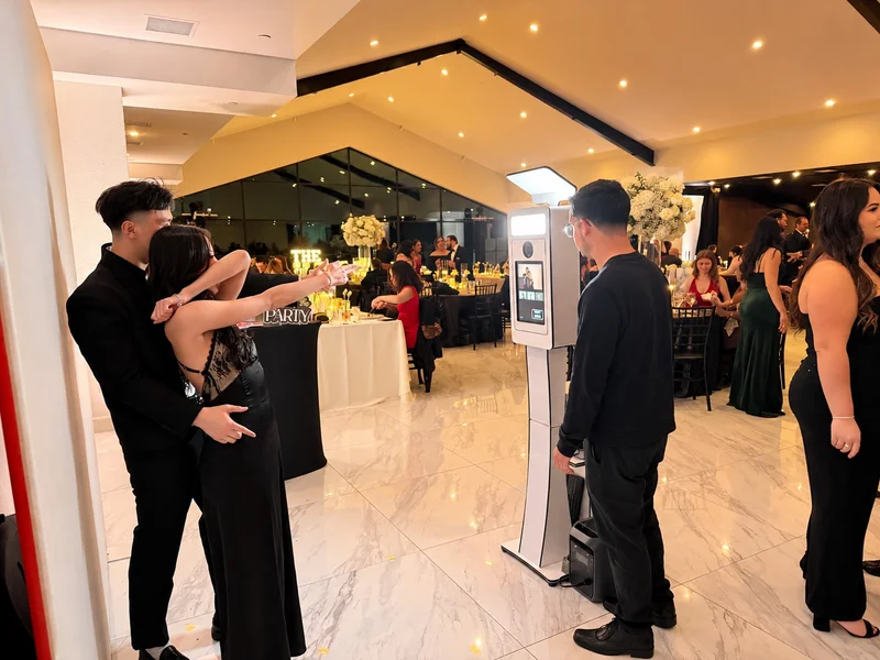 Guests posing together at an Instant Print Photo Booth during a Houston celebration