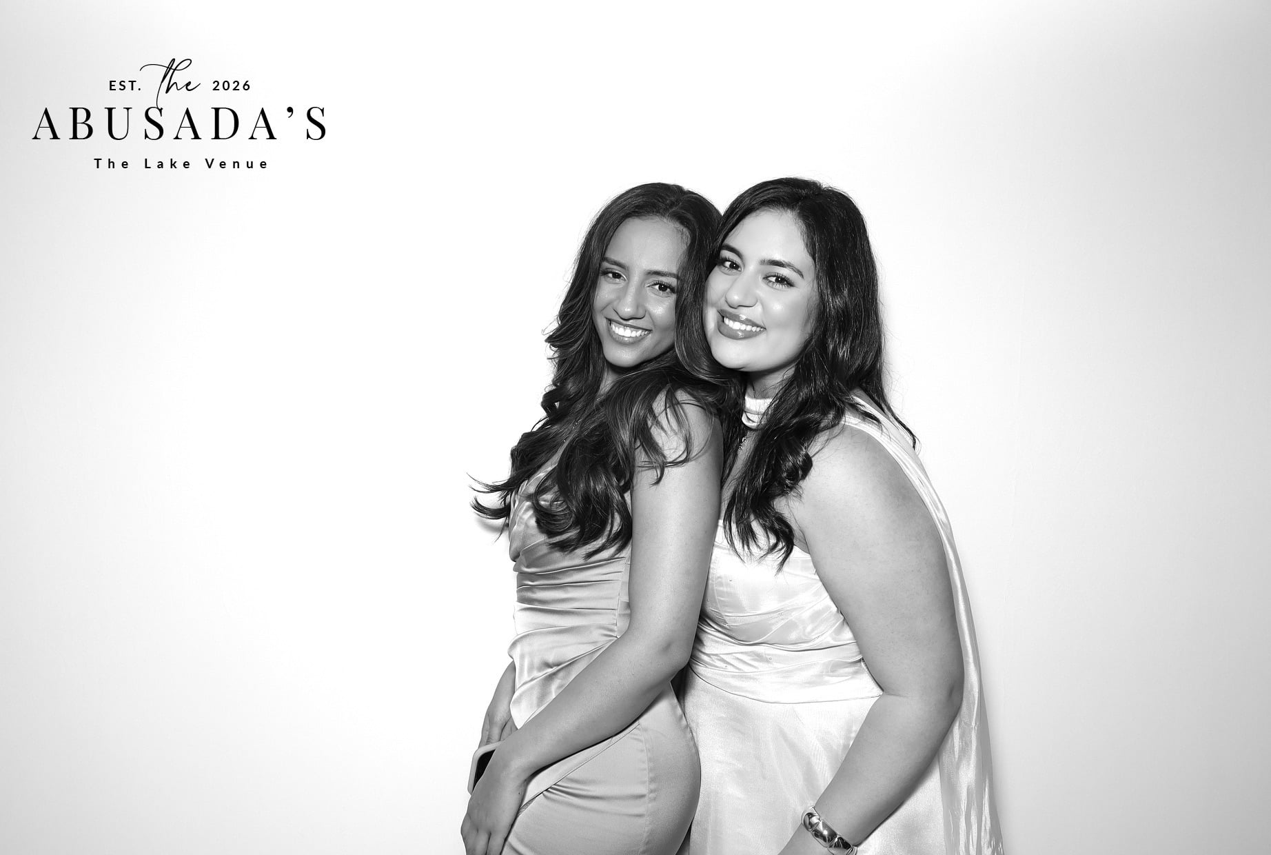 Two women smiling together in a personalized black and white portrait